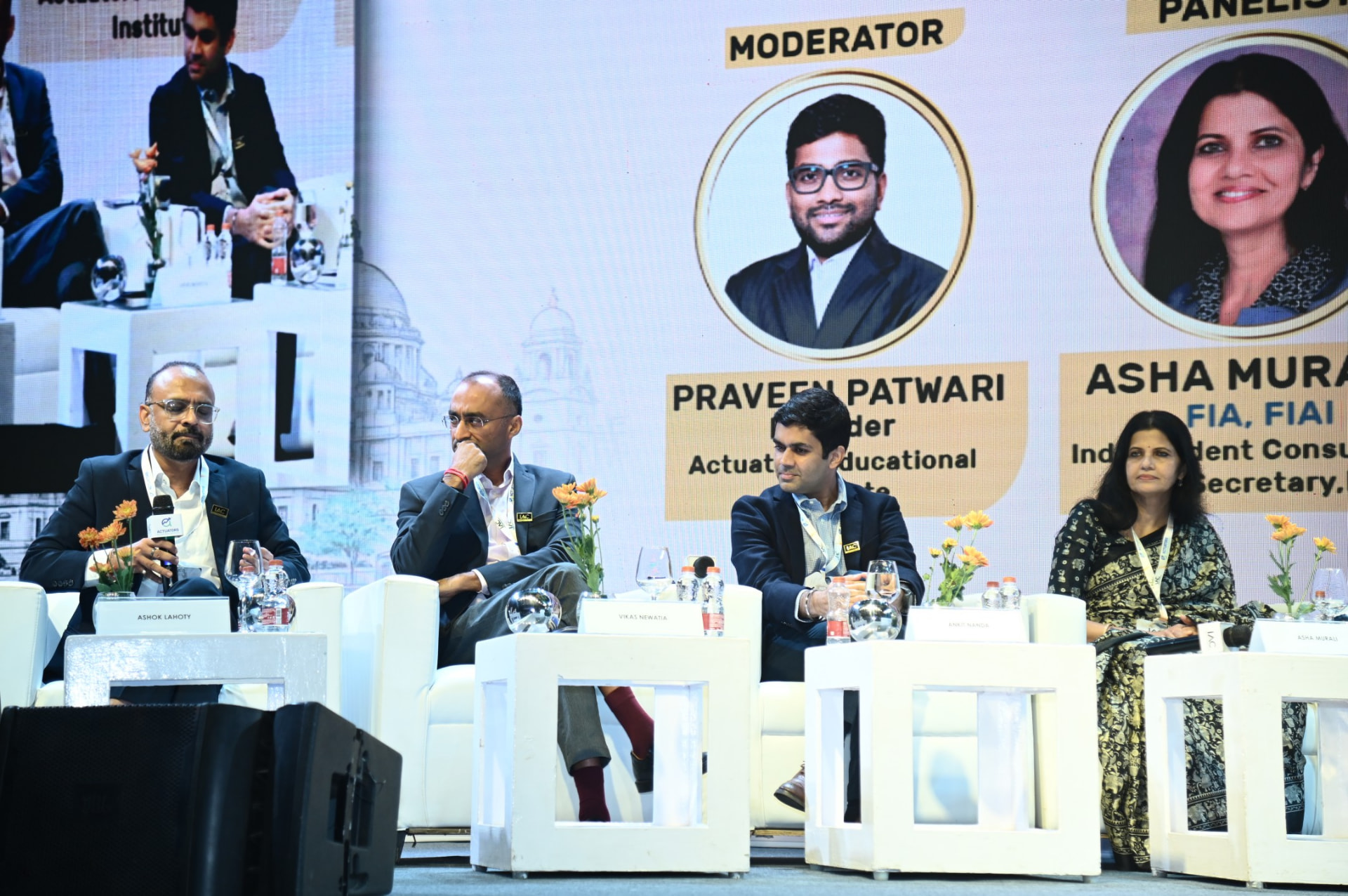 Panellists seated on stage during a discussion at IAC Kolkata 2026